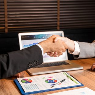 business persons shaking hands.