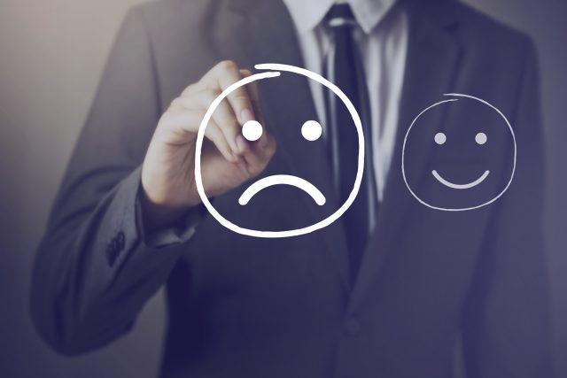 Customer choosing to write unhappy face over happy face